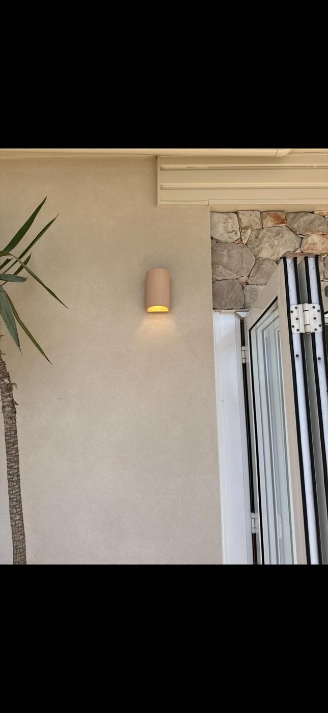 Outdoor wall lights on a rendered wall